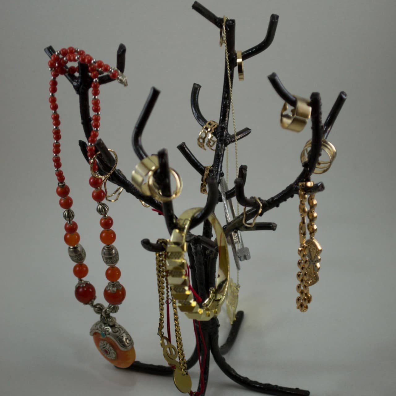 Artisanal black wrought iron jewelry tree holder crafted in Marrakech displaying necklaces and rings